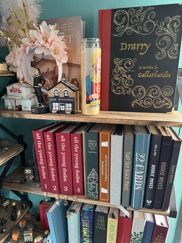 a bookshelf with several hand-bound books on it