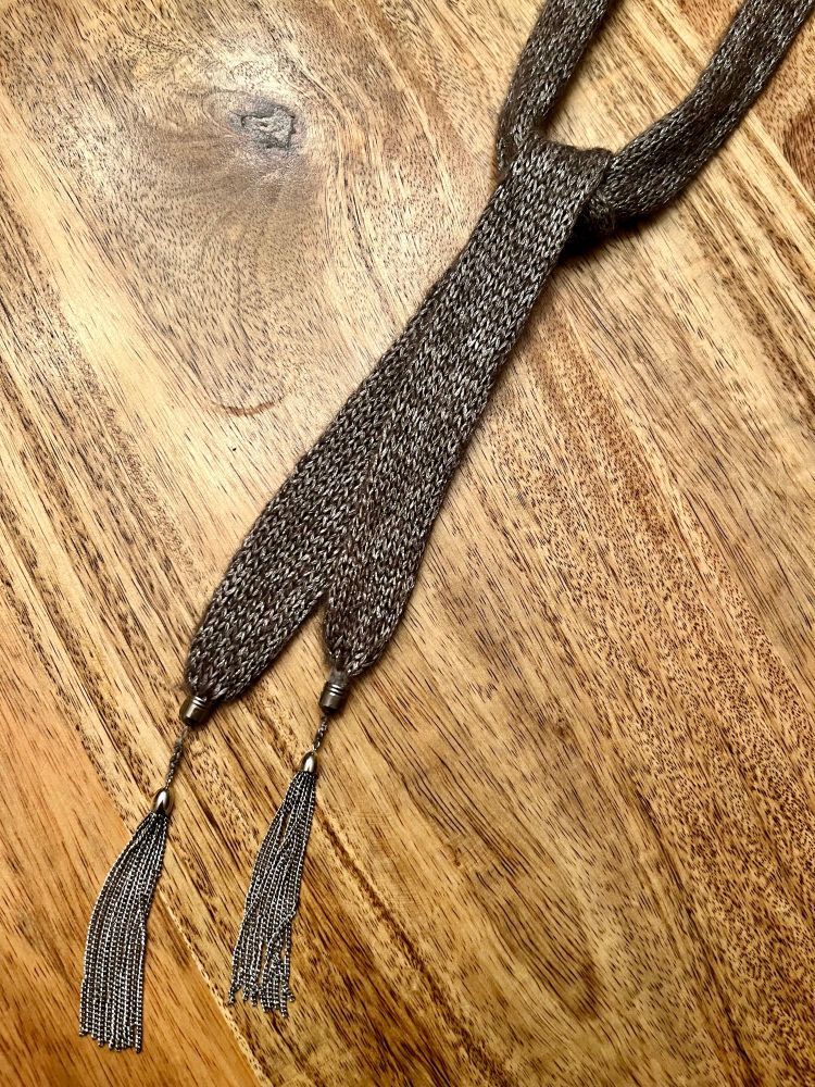 a brown tie with tassles at the ends
