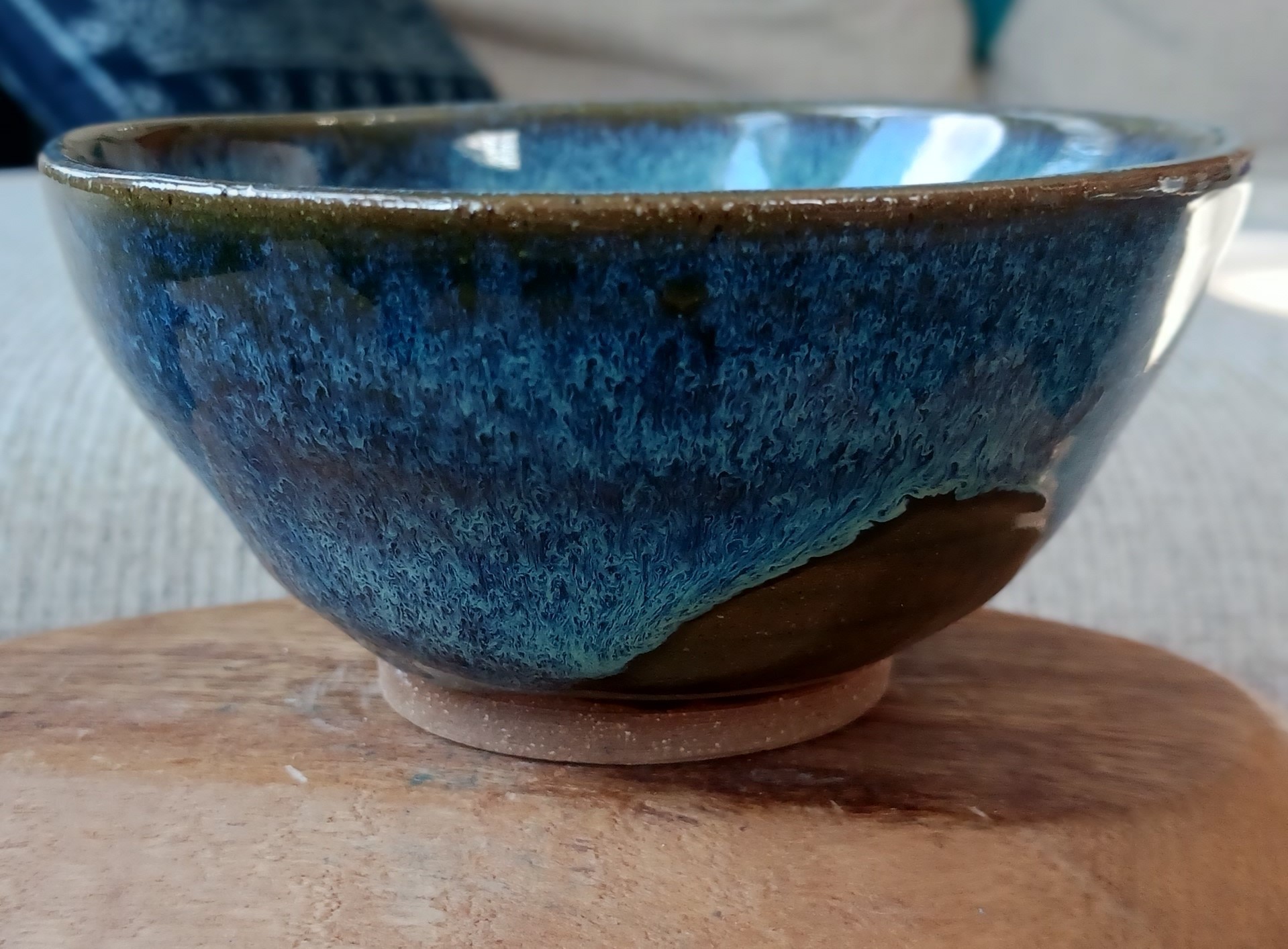 A handmade blue and brown ceramic bowl