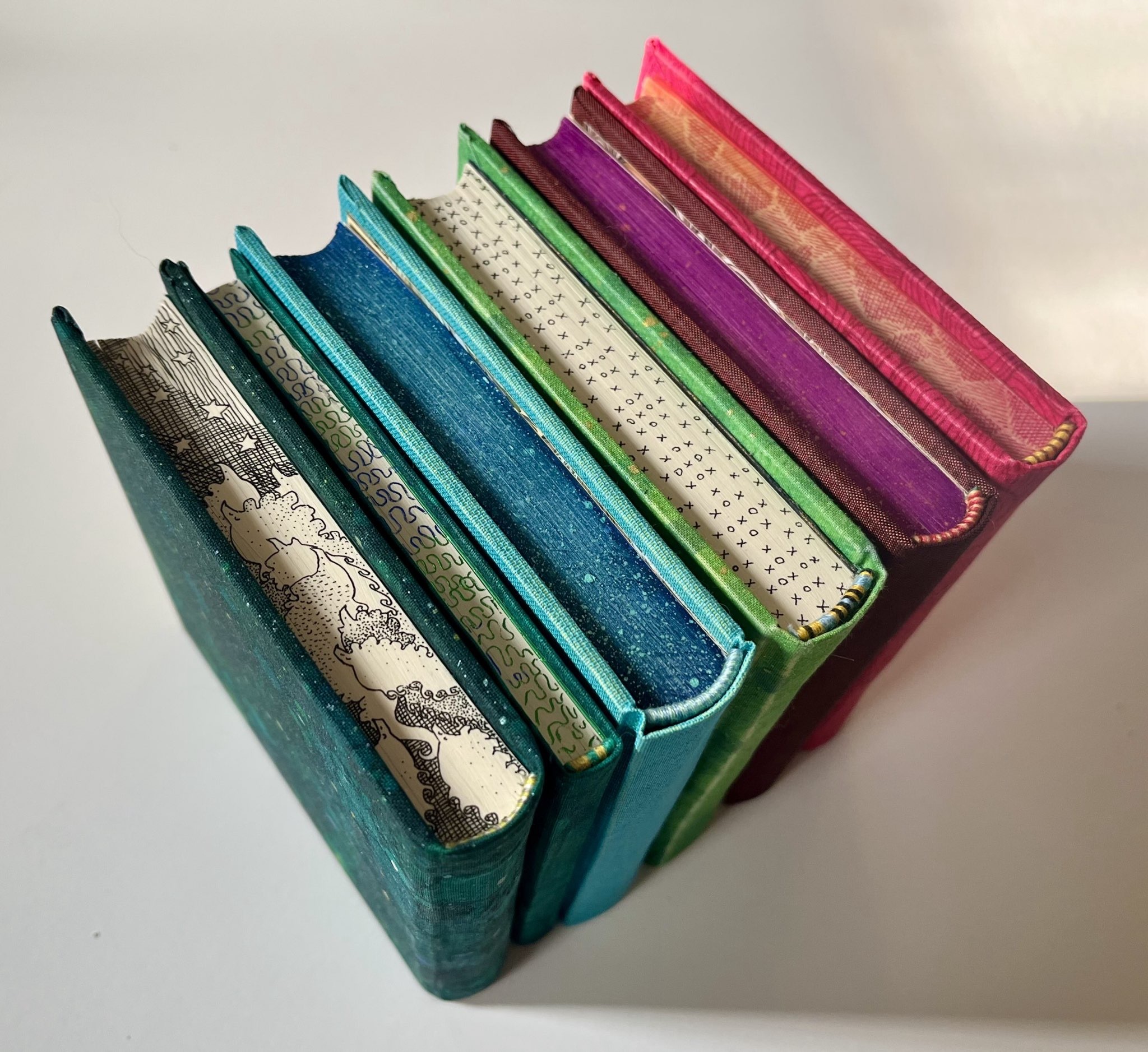 Six handbound books viewed from above